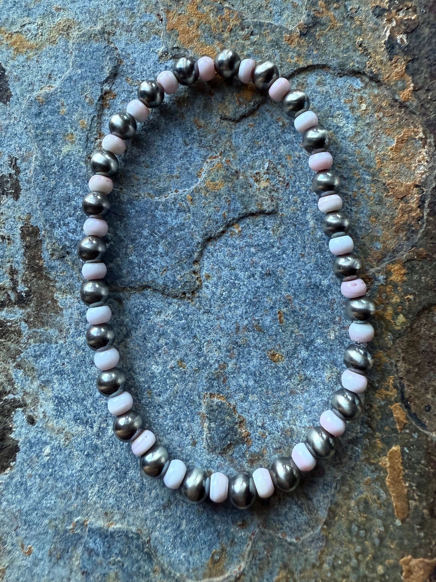 Pink Conch Shell Sterling Silver Pearl Bracelet featuring natural pink conch shell beads and sterling silver accents.