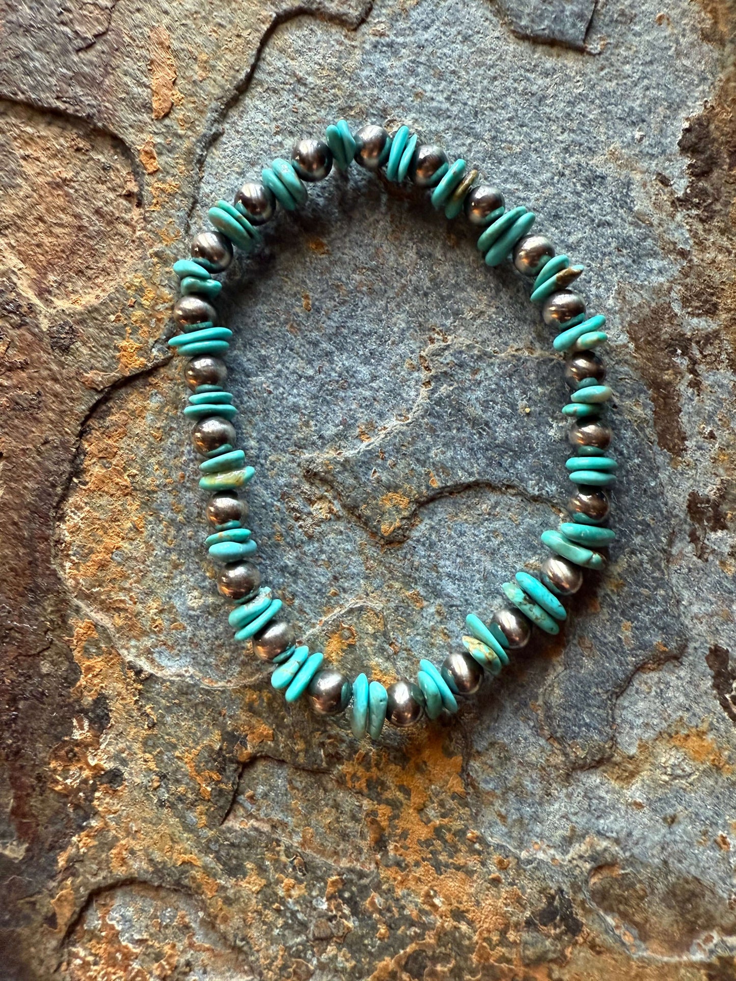 Kingman Chip Sterling Silver Pearl Bracelet Kingman Chip Sterling Silver Pearl Bracelet displayed on textured surface, featuring turquoise chip beads and sterling silver pearls.