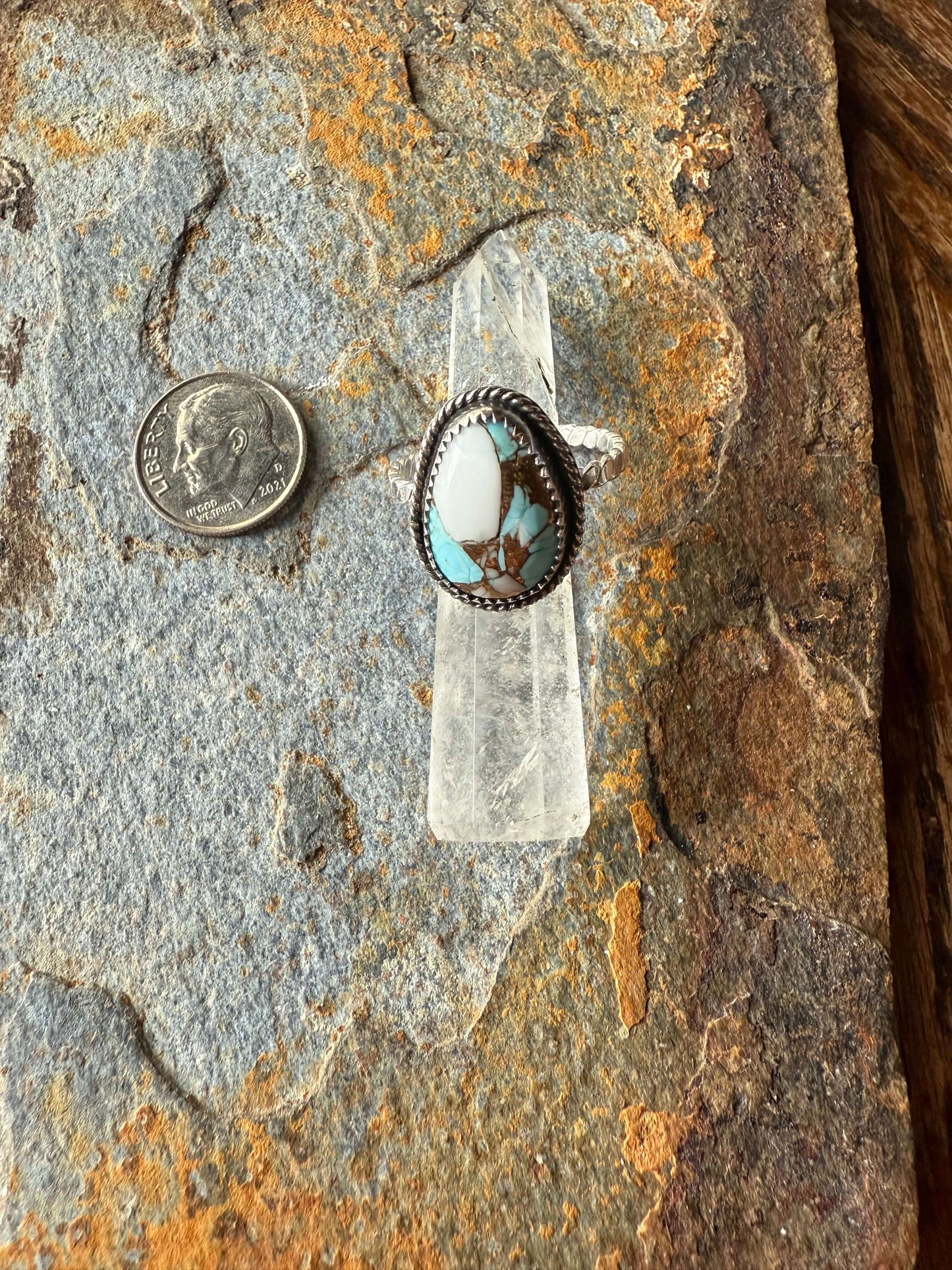 Cotton Candy Dahlia Sterling Silver Ring displayed on a rustic surface with a coin for size reference.