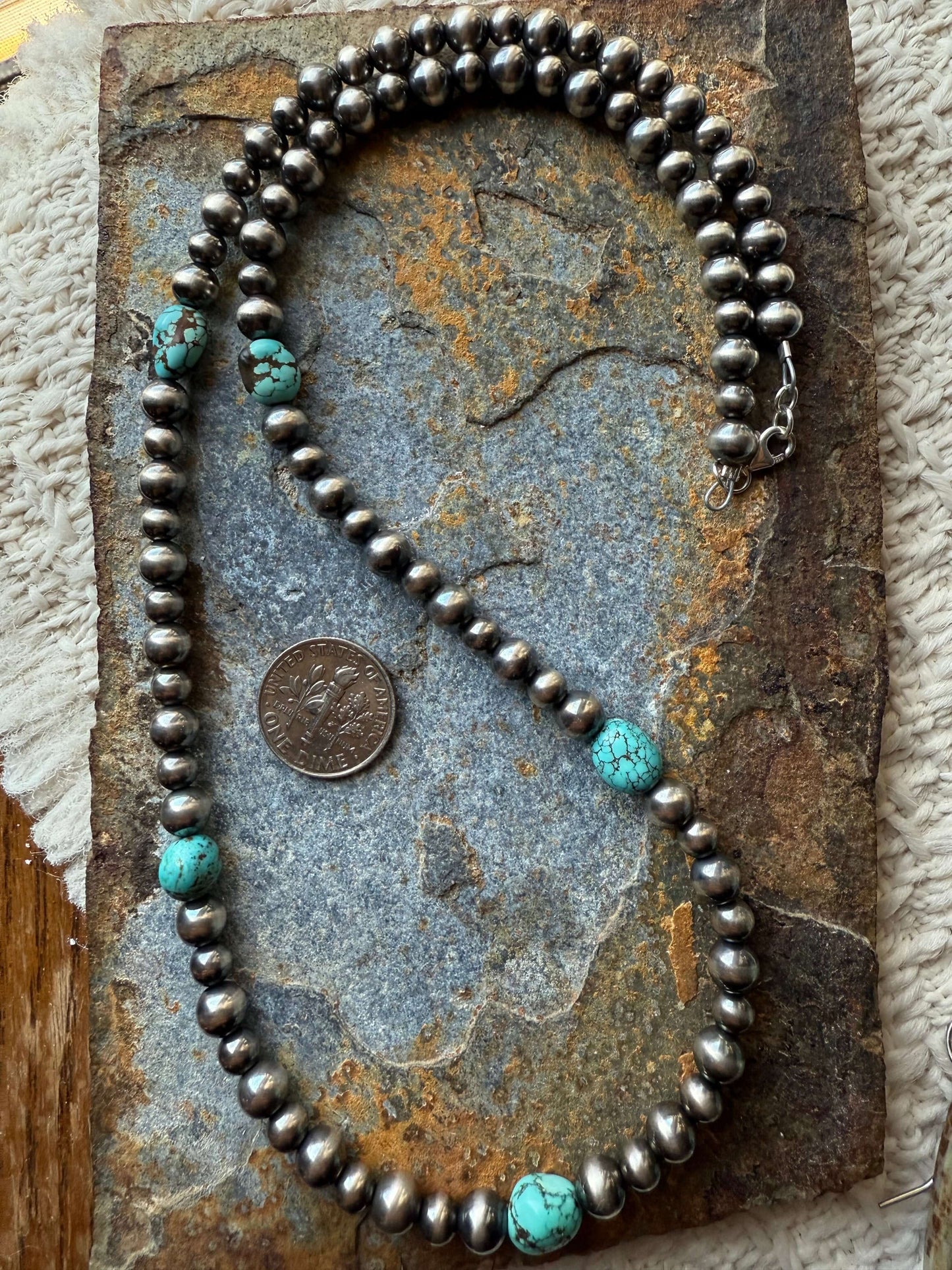 Number 8 Turquoise Pearls Necklace on a stone surface