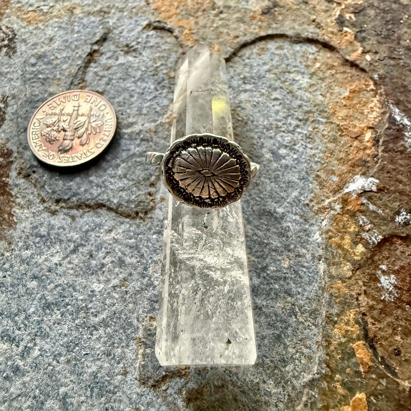 Close-up of a silver concho ring with intricate Western detailing, inspired by Southwestern jewelry. Adjustable fit, perfect for cowgirl and rodeo fashion