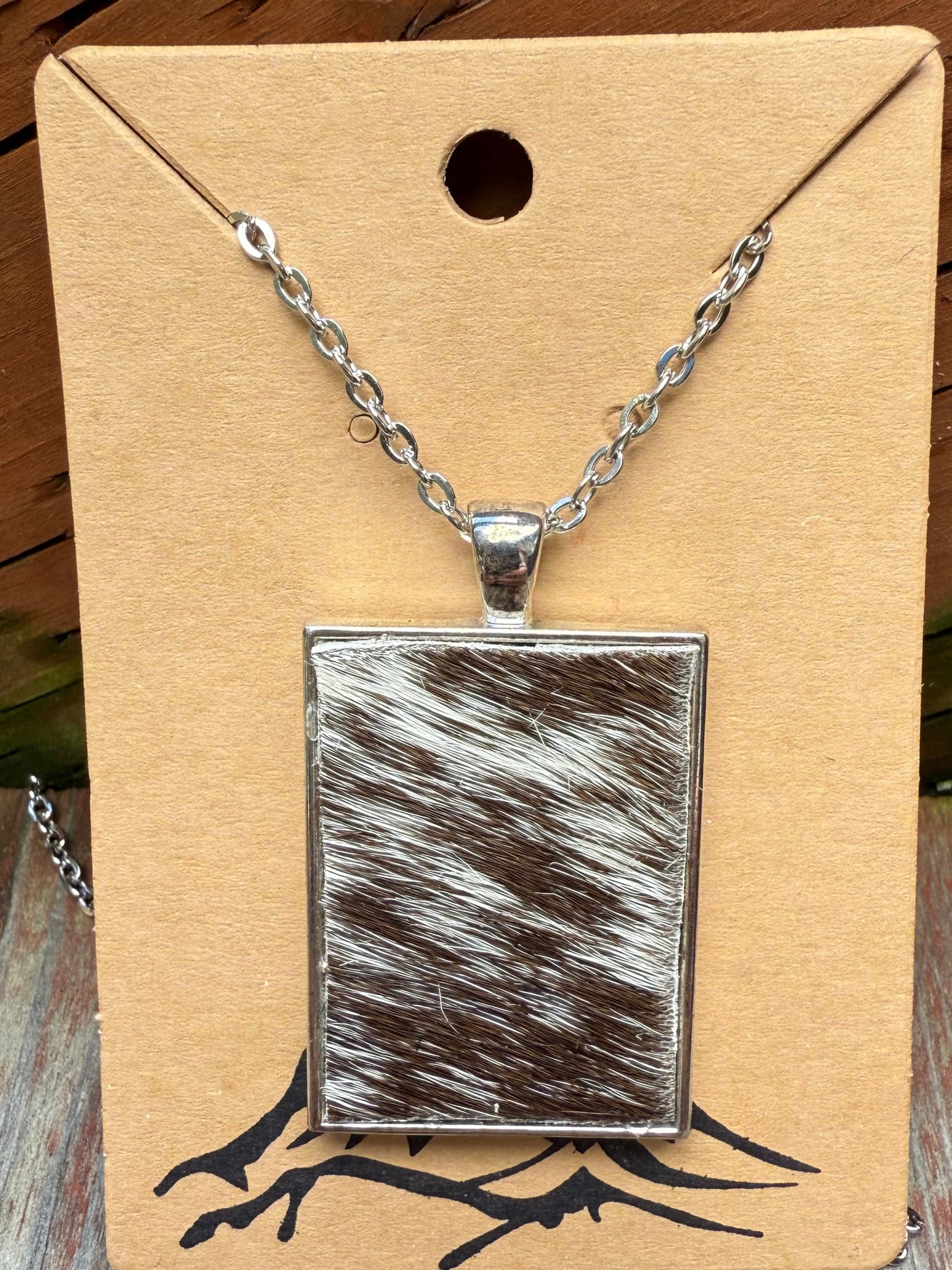 Brown/white hair-on cowhide rectangle shaped pendant with chain