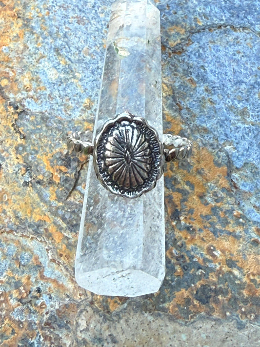Close-up of a silver concho ring with intricate Western detailing, inspired by Southwestern jewelry. Adjustable fit, perfect for cowgirl and rodeo fashion