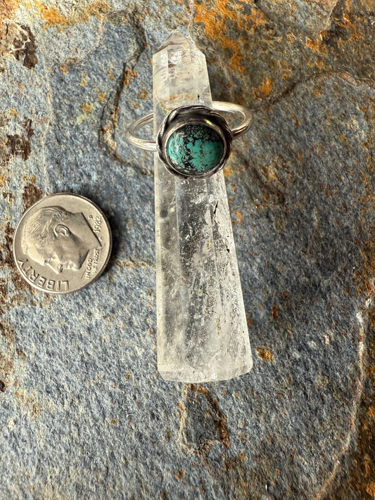 Blue Moon Turquoise Sterling Silver Ring displayed next to a coin for size reference on a textured stone background.