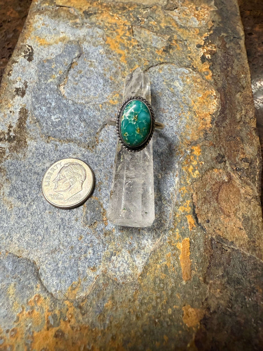 White Water Turquoise Sterling Silver Ring White Water Turquoise Sterling Silver Ring displayed next to a coin on a textured stone surface.