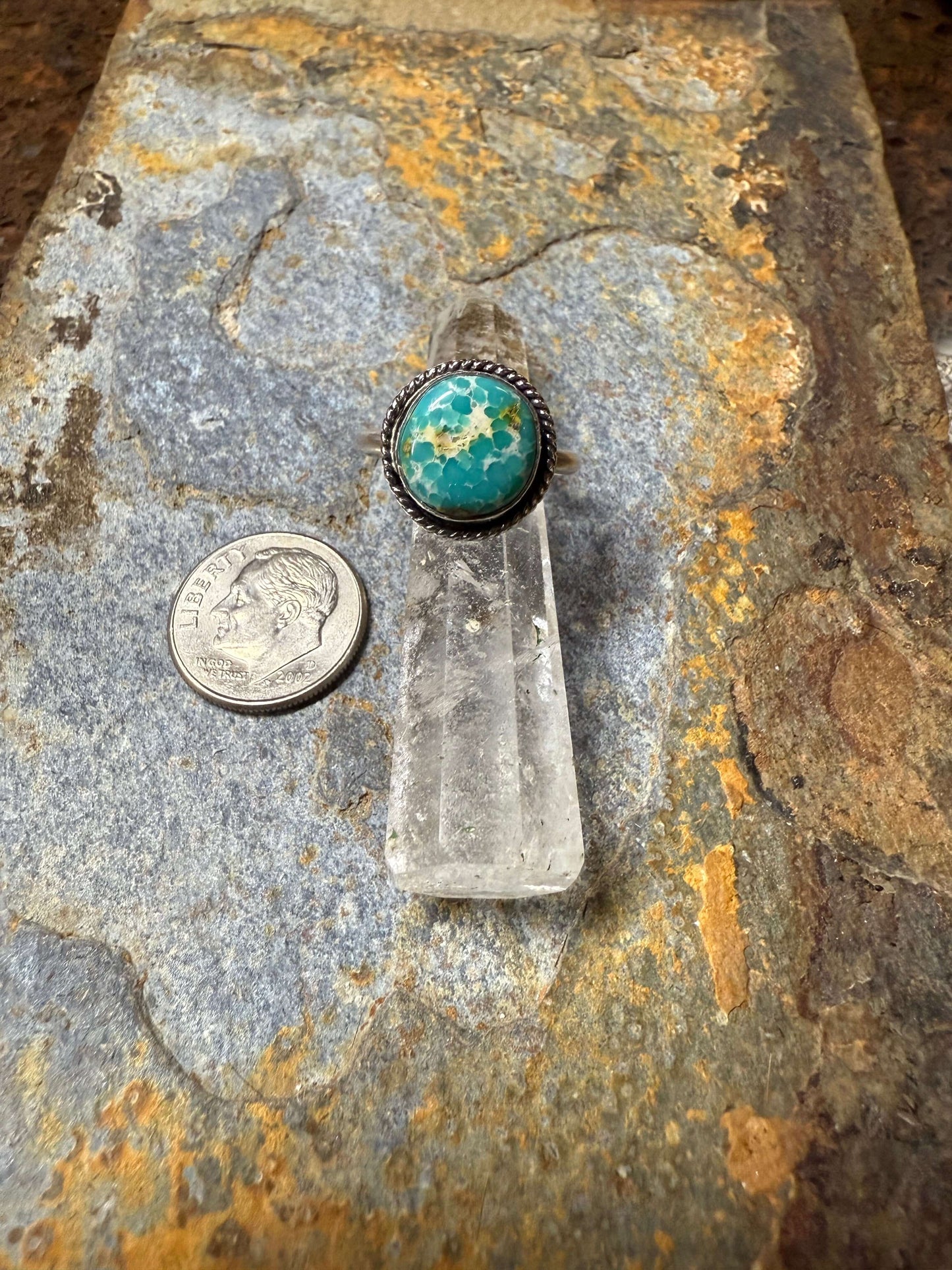 White Water Turquoise Sterling Silver Ring White Water Turquoise Sterling Silver Ring on a natural stone background with a quarter for scale.