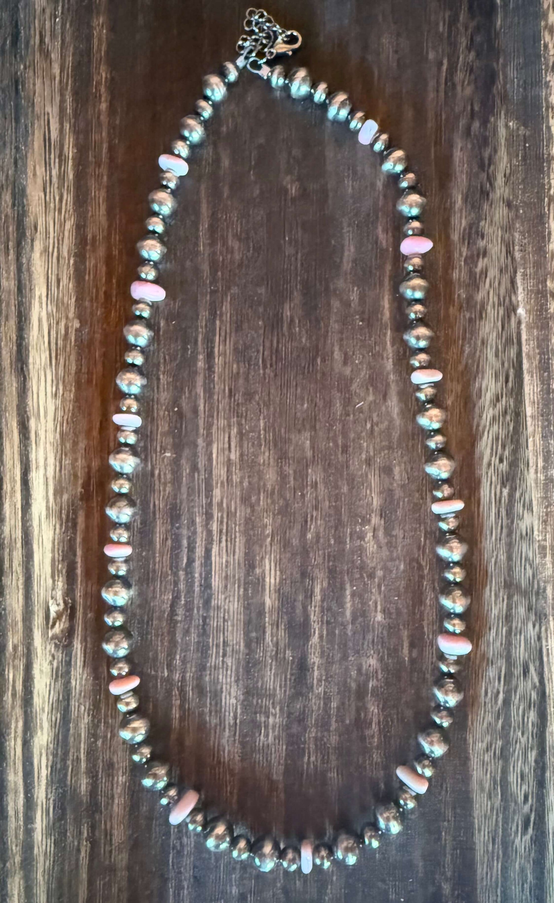 Pink Conch Shell Chip Sterling Silver Pearls Necklace 18 inch displayed on a wooden surface.