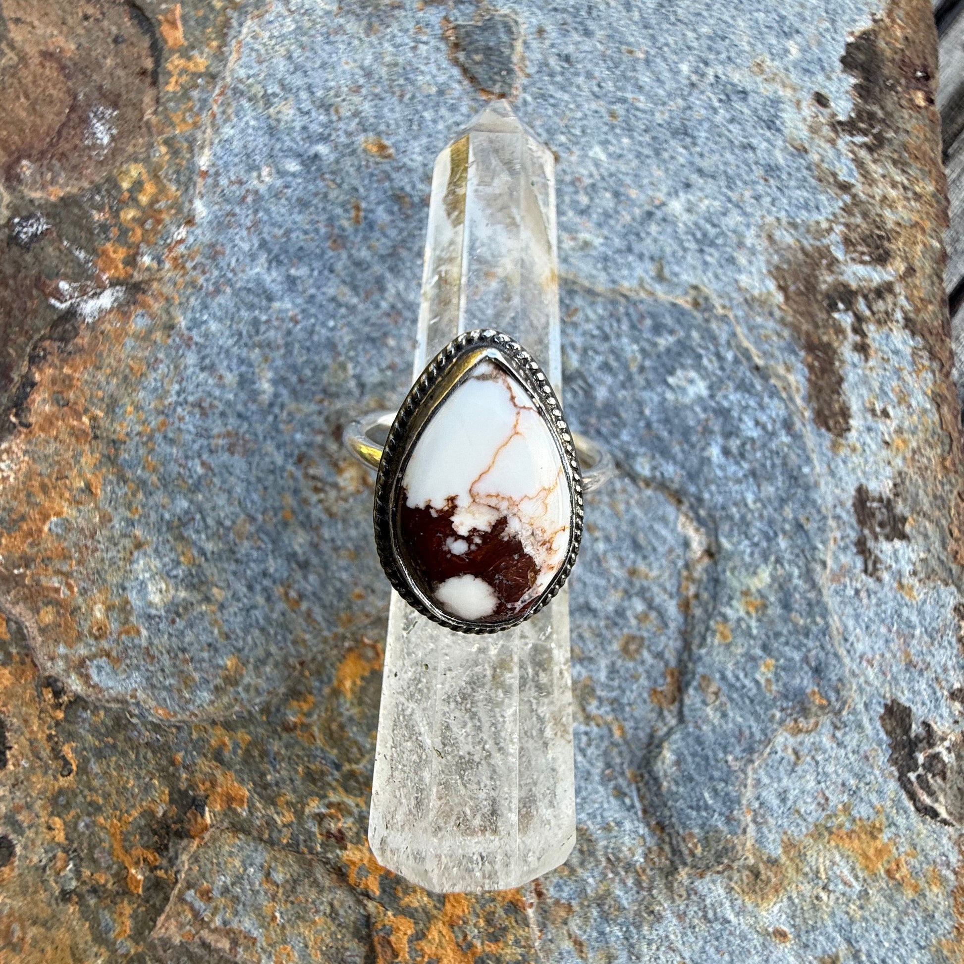 Ring with a stone on a textured stone surface
